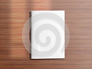 Blank closed brochure on wooden background