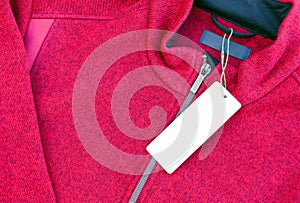 Blank clothing label tag on a red jacket
