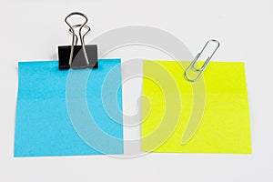 Blank colored sticky notes with clips. Office accessories for listing and memorizing on the table.