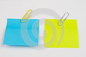 Blank colored sticky notes with clips. Office accessories for listing and memorizing on the table.