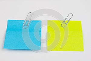 Blank colored sticky notes with clips. Office accessories for listing and memorizing on the table.