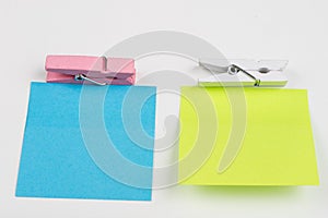 Blank colored sticky notes with clips. Office accessories for listing and memorizing on the table.