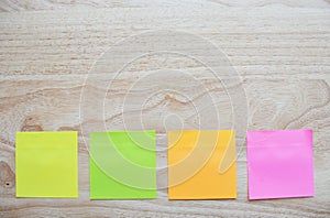 Blank colorful sticky notes on wooden surface