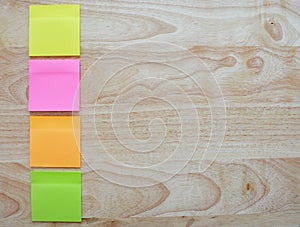 Blank colorful sticky notes on wooden surface