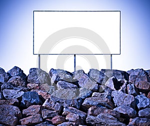 Blank commercial advertising billboard over a large stone blocks wall - concept image with copy space