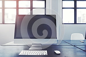 Blank computer screen on a black office table