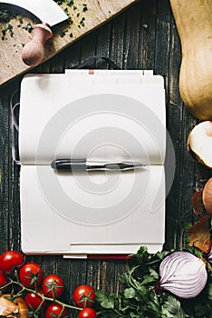 Blank cookbook with fresh ingredients for cooking and seasoning