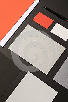 Blank corporate stationery on dark background. Mocks the brand. orange tones photo