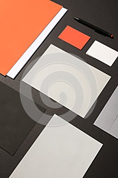 Blank corporate stationery on dark background. Mocks the brand. orange tones photo