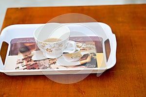 Blank cup on a tray with a kettle.