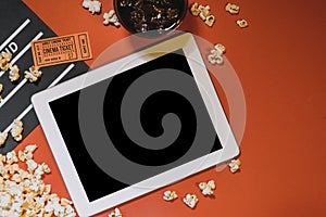 Blank digital tablet, popcorn, filmstrip, cinema and movie online streaming concept