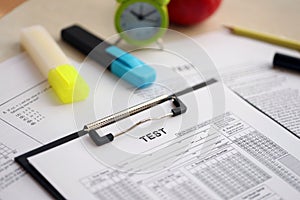 Blank educational test for students lies on table in classroom with pencil