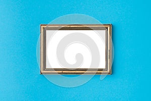 Blank empty golden frame on blue background. Art gallery, museum