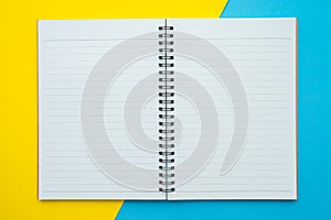 Blank empty notepad on yellow blue background - Business education stationery