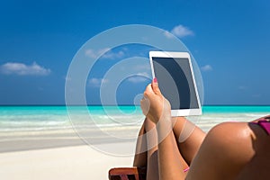 Blank empty tablet computer in the hands of women on the beach