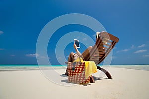 Blank empty tablet computer in the hands of women on the beach
