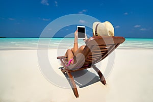 Blank empty tablet computer in the hands of women on the beach