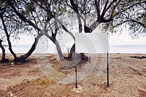 Blank empty white sign post on the beach