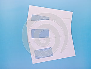 Blank envelopes with address window on blue background. White paper envelopes mockup for business correspondence  postal