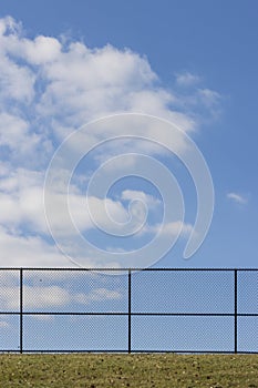 A blank fence on blue sky day