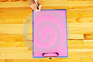 Blank Folder with Pink Paper. Hand that Holding Folder and Handle on White Background. Copyspace. Place for Text