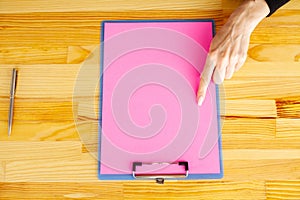 Blank Folder with Pink Paper. Hand that Holding Folder and Handle on White Background. Copyspace. Place for Text