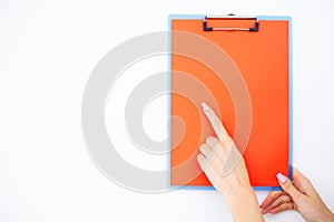 Blank Folder with ?range Paper. Hand that Holding Folder and Handle on White Background. Copyspace. Place for Text.