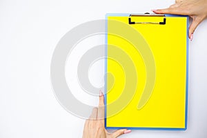 Blank Folder with Yellow Paper. Hand that Holding Folder and Handle on White Background. Copyspace. Place for Text