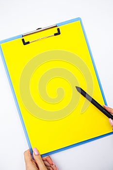 Blank Folder with Yellow Paper. Hand that Holding Folder and Handle on White Background. Copyspace. Place for Text