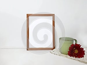 Blank frame mockup, ceramic cup with red flower  on white