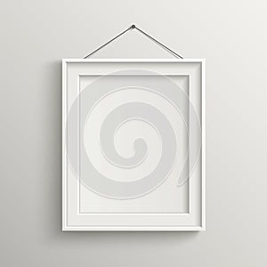 Blank frame on white wall with shadow