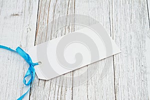 Blank gift tag with a blue ribbon