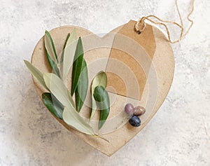 Blank gift tag on table with olive tree branch