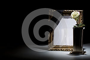 Blank gilded mourning frame with bronze vase, white rose, and b