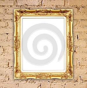 Blank golden frame on brick stone wall