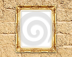 Blank golden frame on brick stone wall