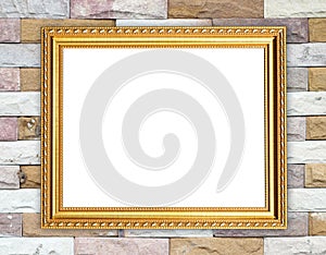 Blank golden frame on brick stone wall