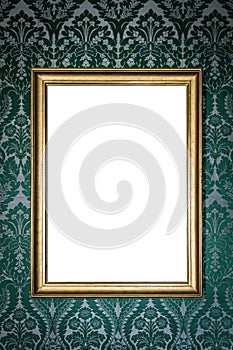 blank golden picture frame hanging on wall on floral vintage wallpaper