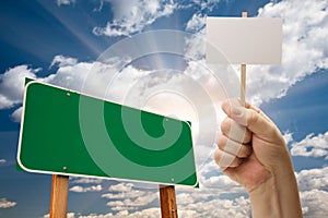 Blank Green Road Sign and Man Holding Poster