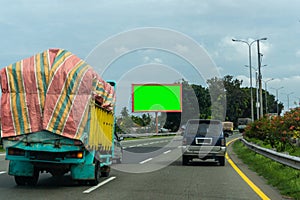 Blank green screen billboard at the highway. Copy space signboard or outdoor billboards on freeway,