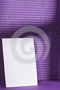 Blank greeting card, flyer or invitation card mockup with shadow, Valentines or women\'s day heart near purple wall