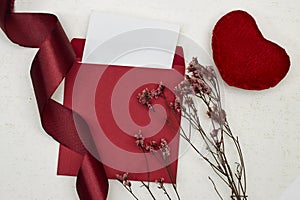 Blank greeting card, flyer or invitation card mockup with Valentines or women\'s day hearts and gypsophila, red ribbon