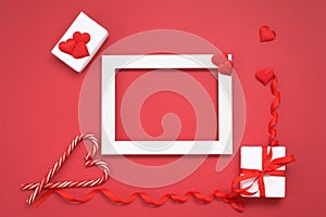 Blank greeting card with place for text Valentine`s day gift with red ribbon and hearts on a red background. mockup