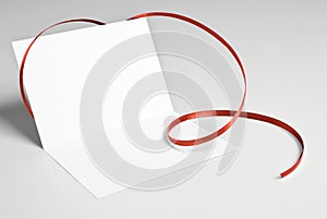 Blank greeting card with red ribbon