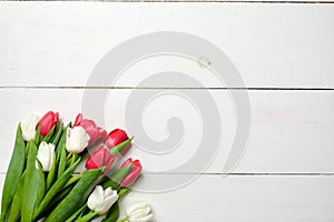 Blank greeting card with tulips flowers on white wooden table. Romantic wedding card, greeting card for womans or mothers day, bir