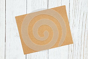 Blank greeting card on weathered whitewash textured wood background