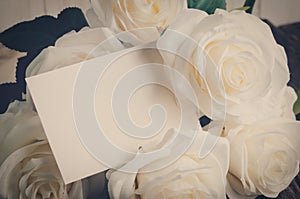 Blank greeting card with white artificial rose