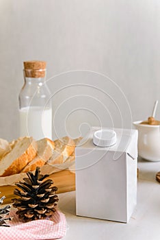 Blank half liter milk box tetra pack  with lid on a table with breakfast. package template, mockup of a retail container for