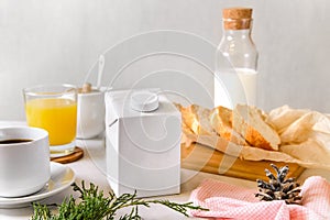 Blank half liter milk box tetra pack  with lid on a table with breakfast. package template, mockup of a retail container for