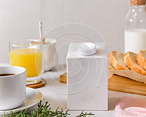 Blank half liter milk box tetra pack  with lid on a table with breakfast. package template, mockup of a retail container for